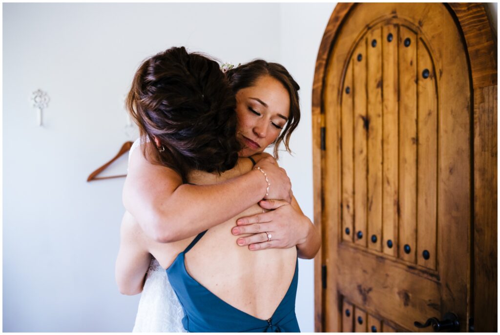 Beth hugs her sister and Maid of Honor on her wedding day.