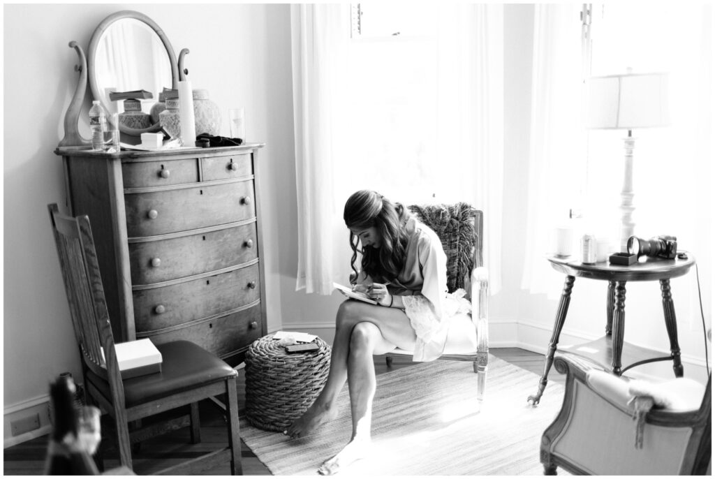 Black and white photo of bride getting ready in a bridal suite in Ithaca, NY during her Ithaca Farmer's Market Wedding.