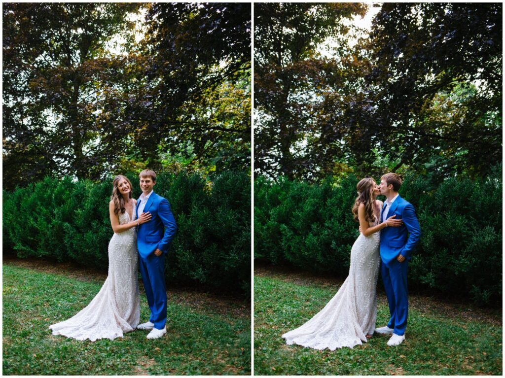 Vertical portraits of the bride and groom in front of green shrubs with the sun shining through. The groom wears a blue suit and the bride wears a white lace wedding gown. 