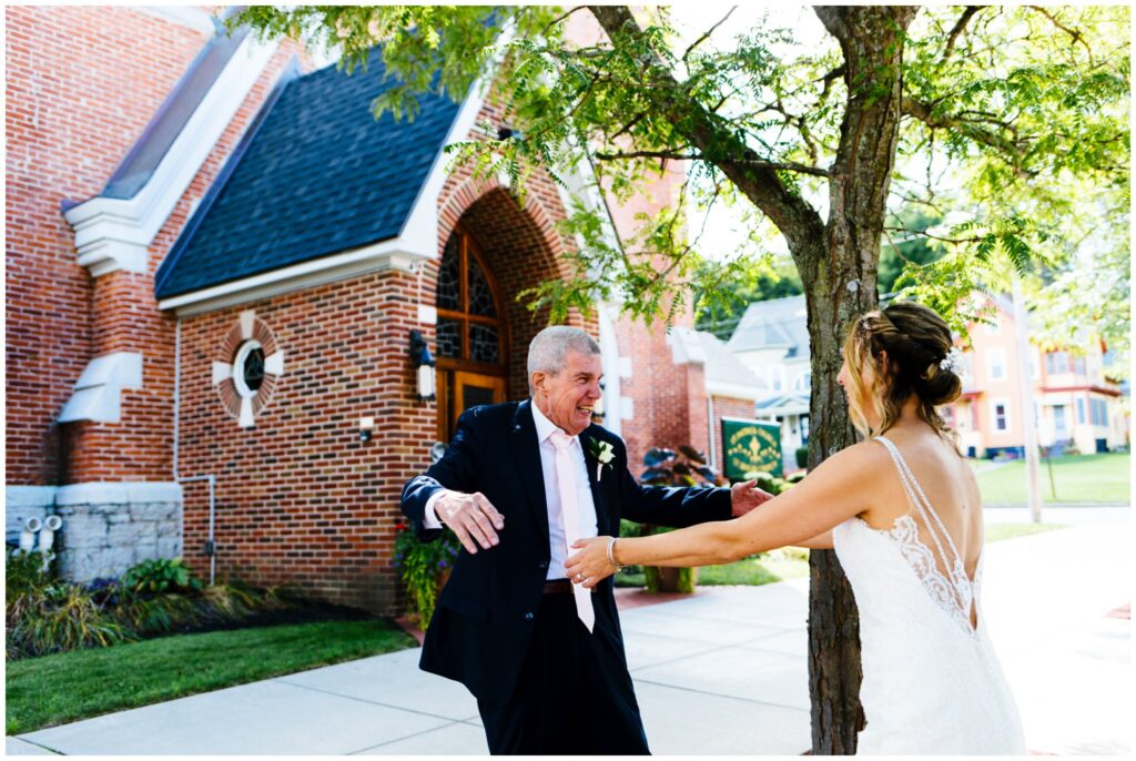 a bride and her father see each other for the first time on her wedding day at St. Pauls Church in Syracuse, NY