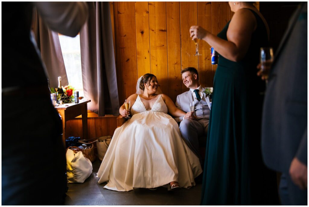 Bride and groom relax before their wedding ceremony at Camp Gorham in the adirondacks.