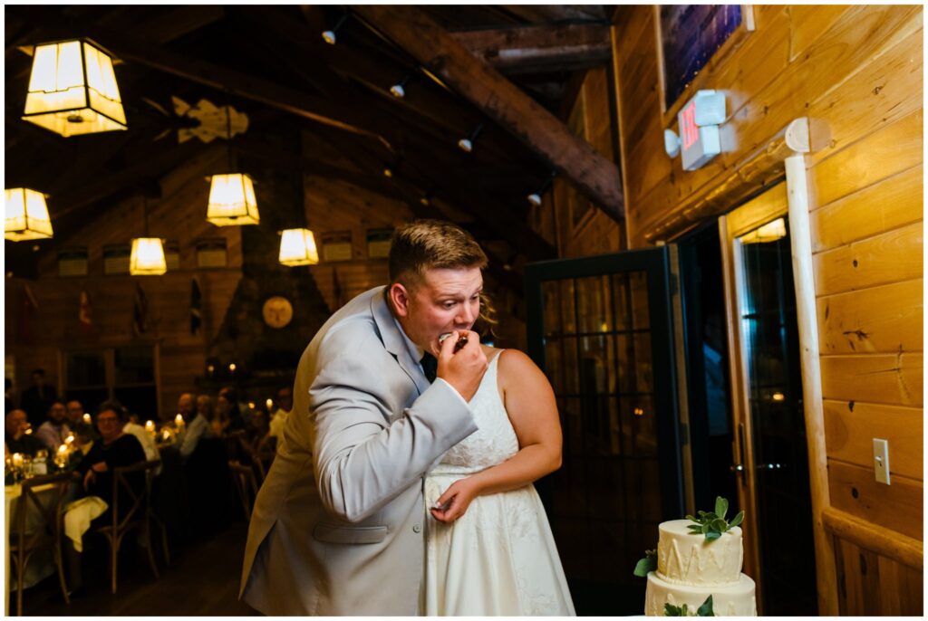Groom feeds himself cake on his wedding day.