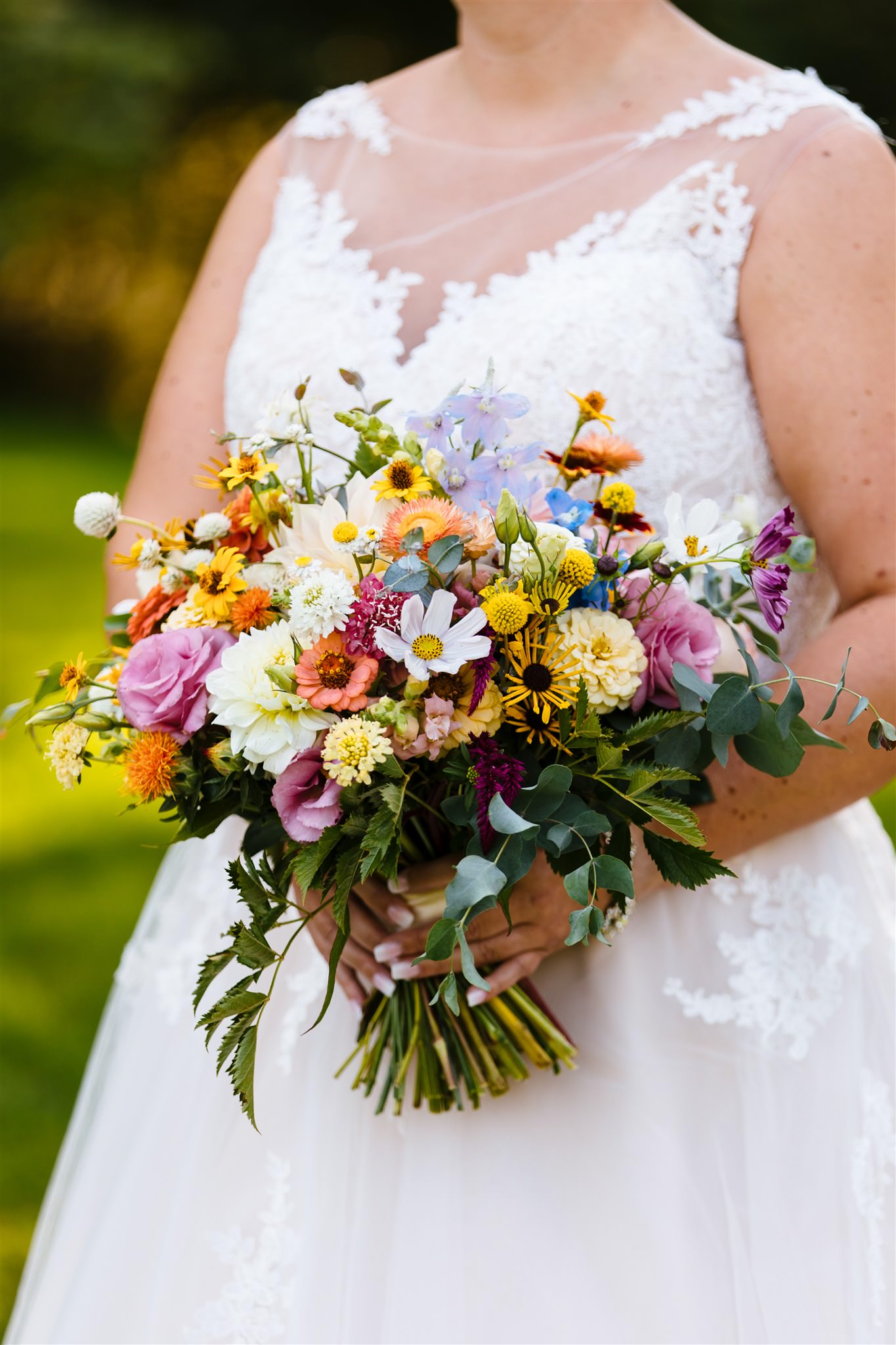 A close up of a gorgeous colorful bridal bouquet of flowers.