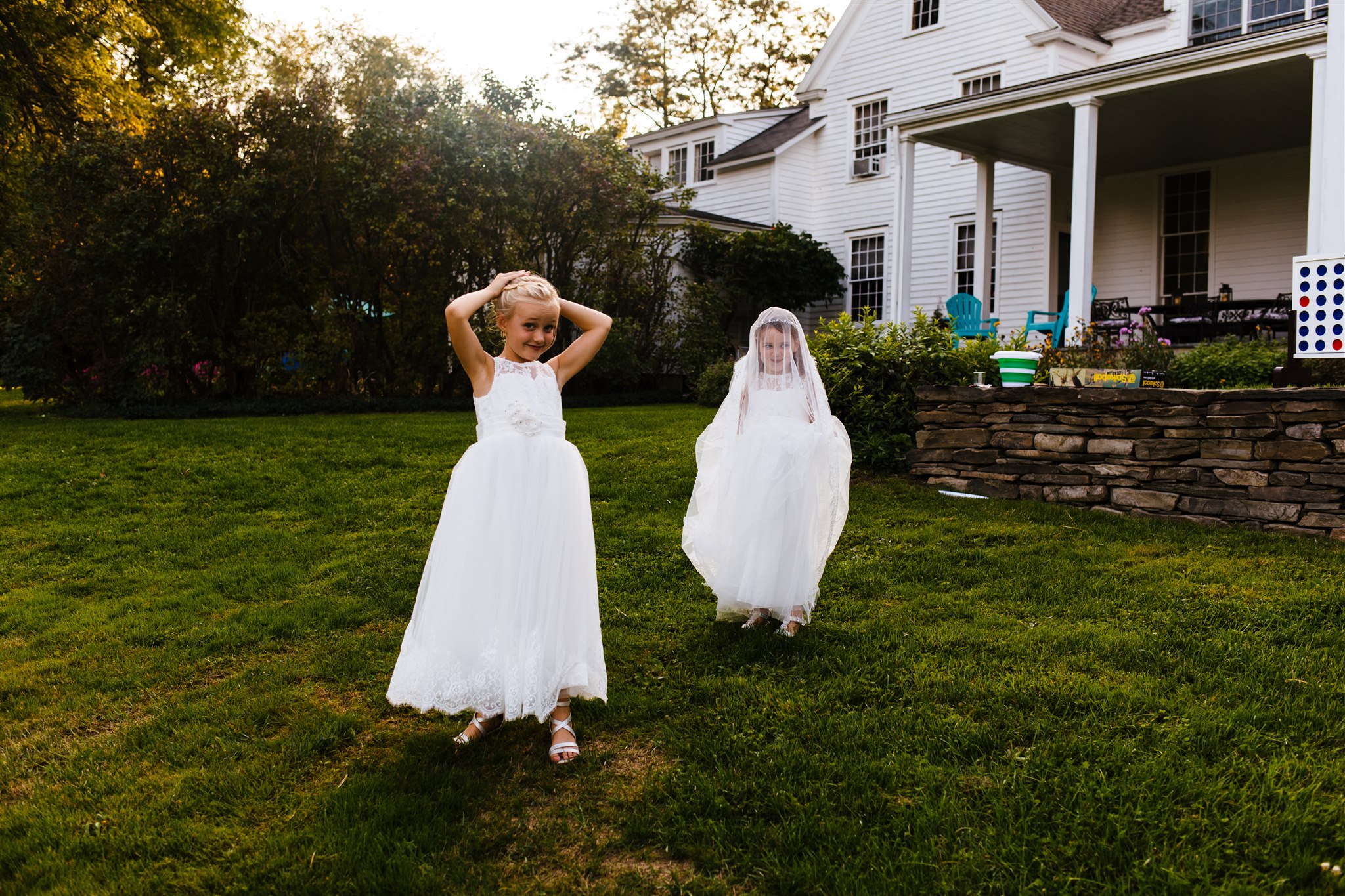 Two flower girls act silly during the wedding day.