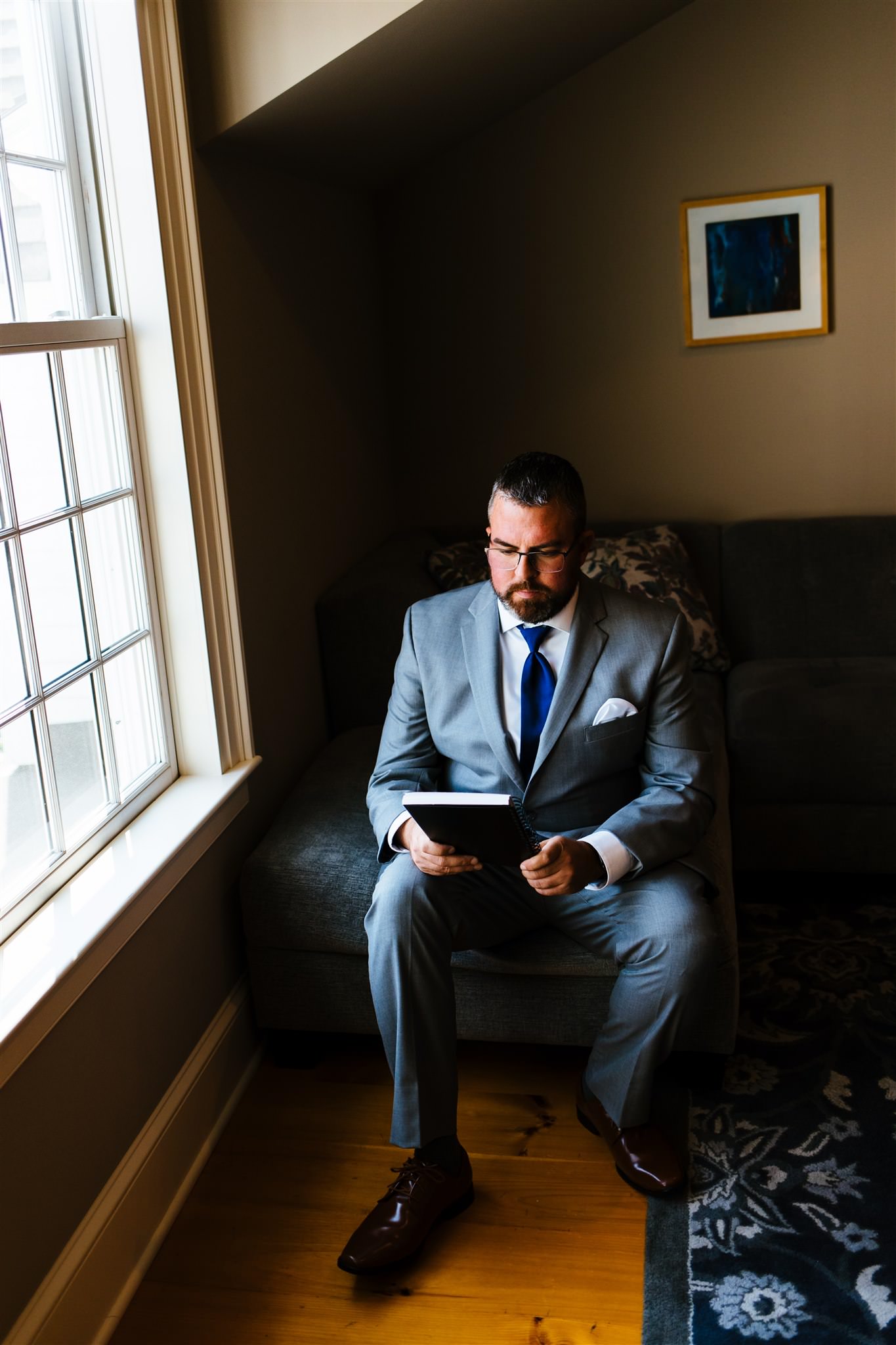 The groom reads a note as he gets ready for his wedding day.