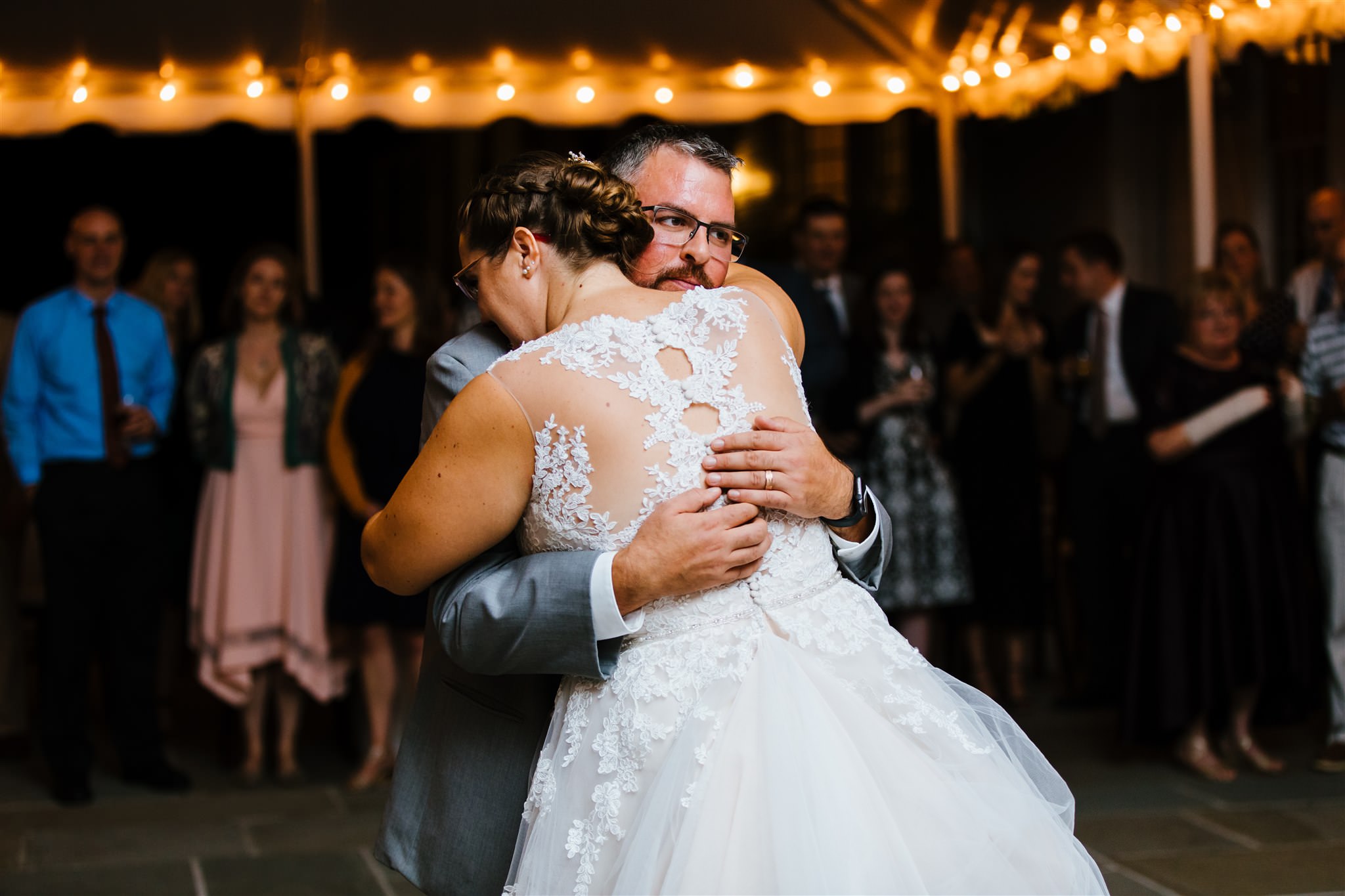 The bride and groom share a first dance under a tent at their finger lakes wedding. 
