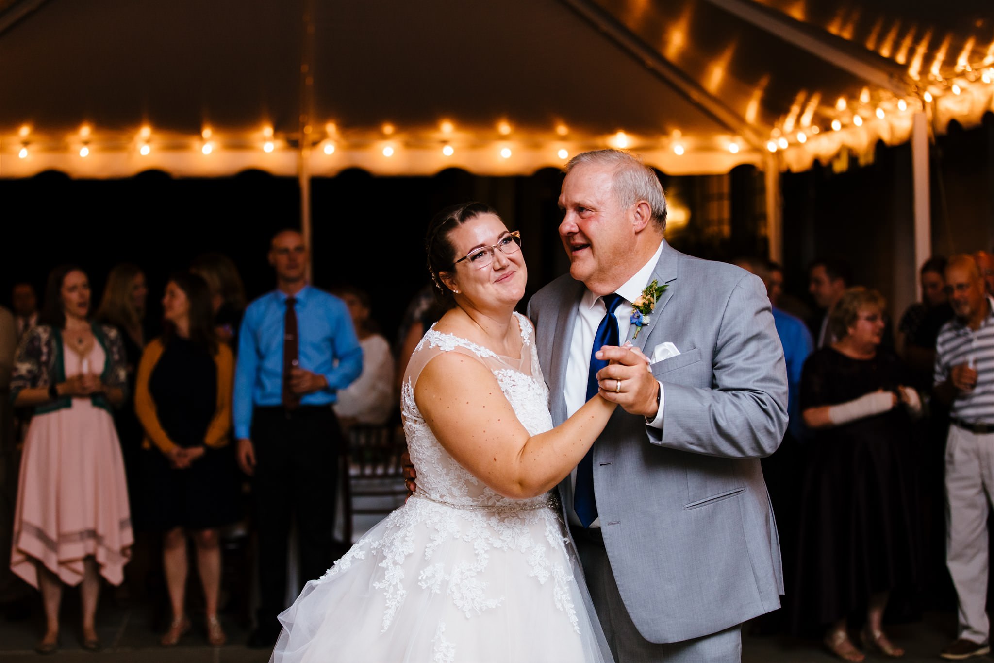 The bride and her father share a first dance under a tent at their finger lakes wedding. 