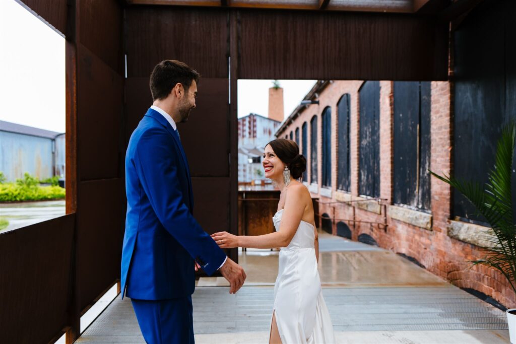 Bride and groom share a first look outside at their Greylock Works Wedding in the Berkshires by Berkshires wedding photographer, Calypso Rae Photography.