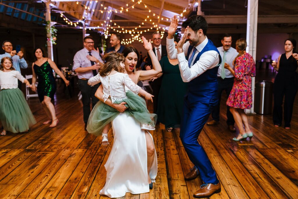 Bride groom and daughter dance at their greylock works wedding