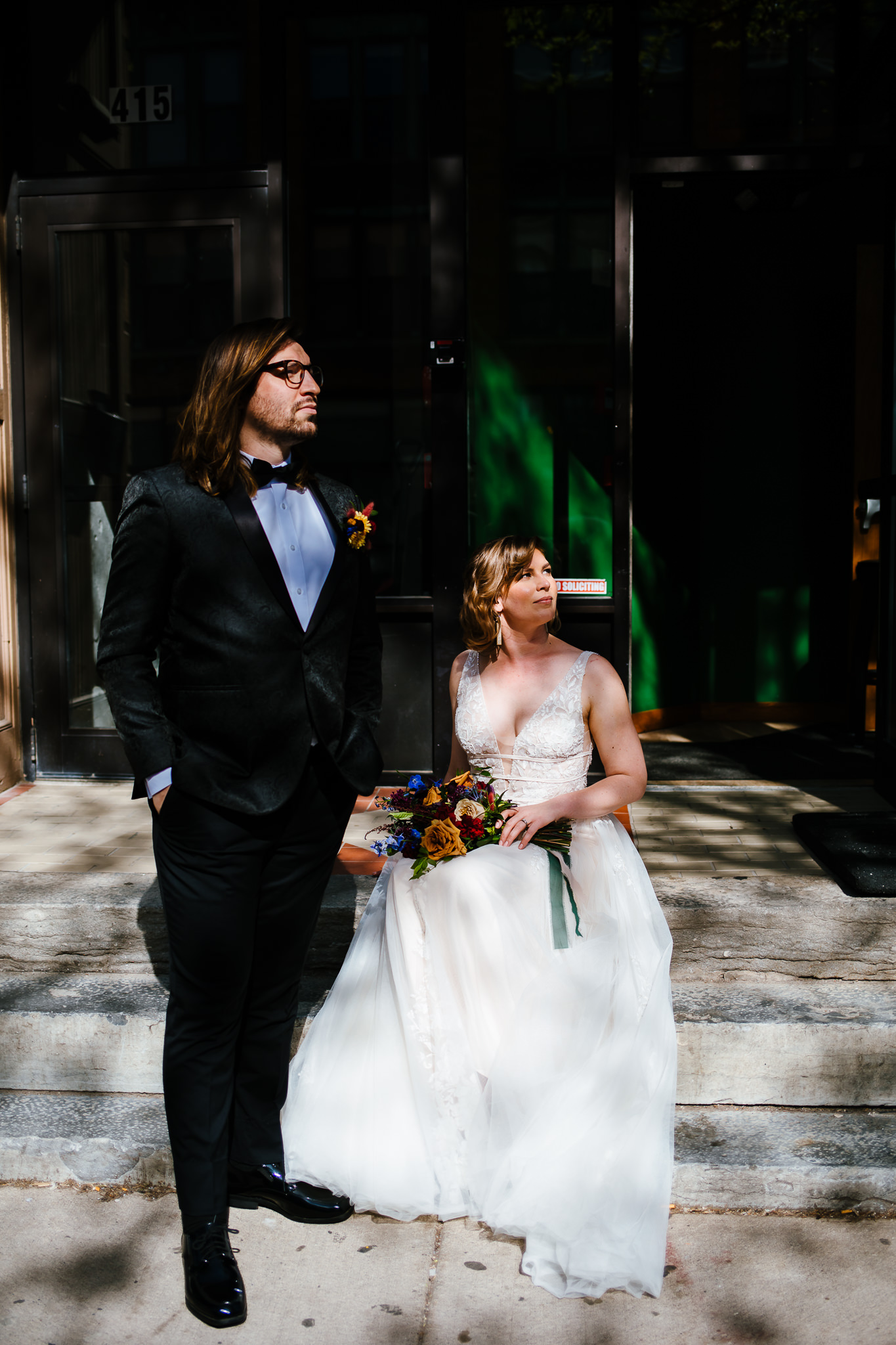 Artsy photos of the bride and groom in front of a building.