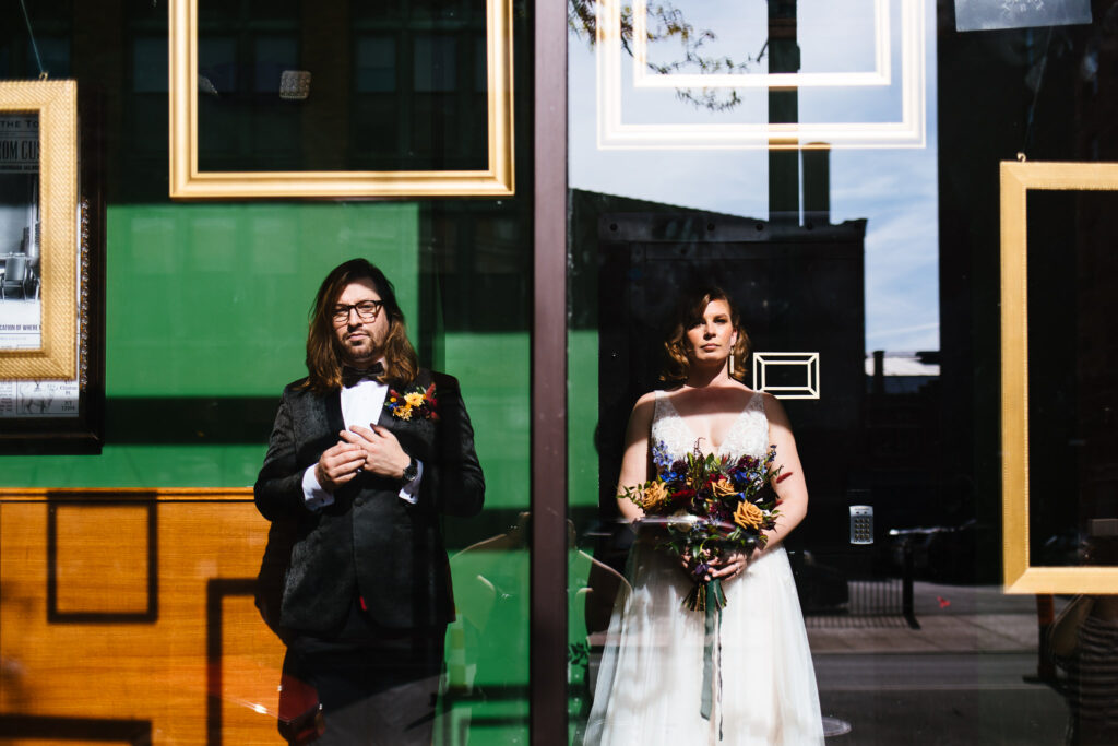 Artsy photos of the bride and groom in front of the syracuse Gilded club. 