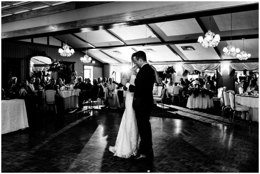 A couple dances in the ballroom of Belhurst Castle, one of many finger lakes wedding venues.