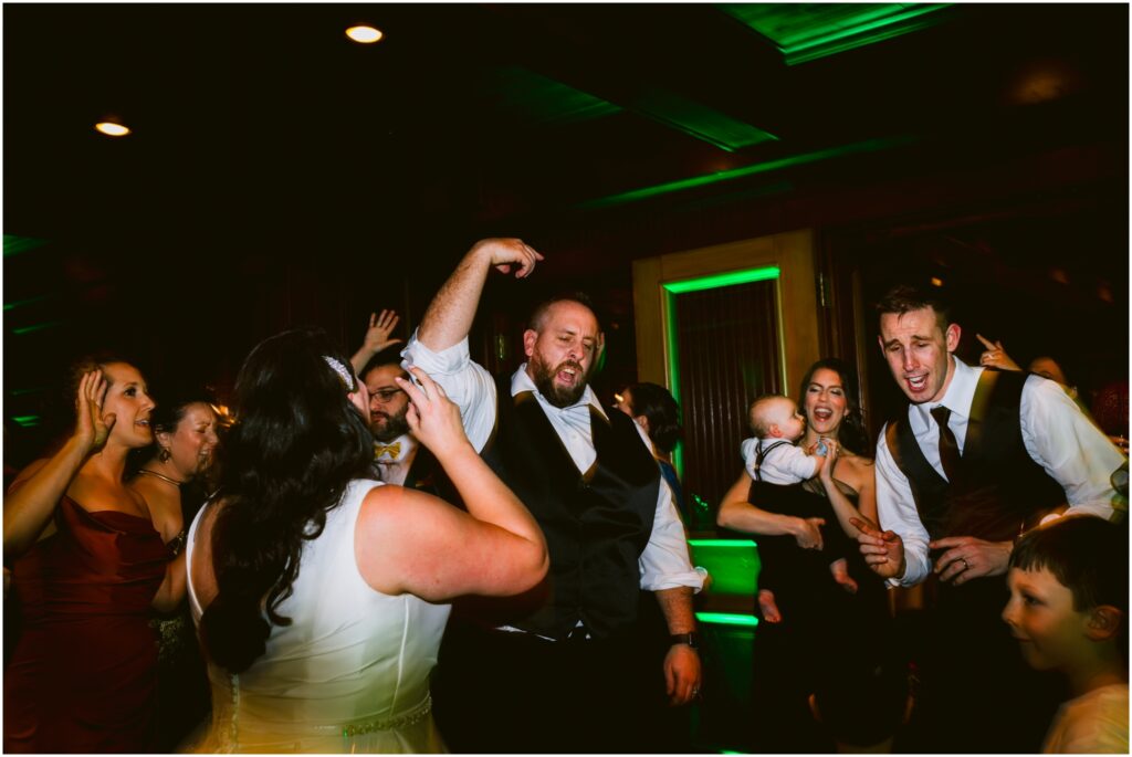 Groom dances at their wedding reception at the Sherwood Inn in Skaneateles, NY.