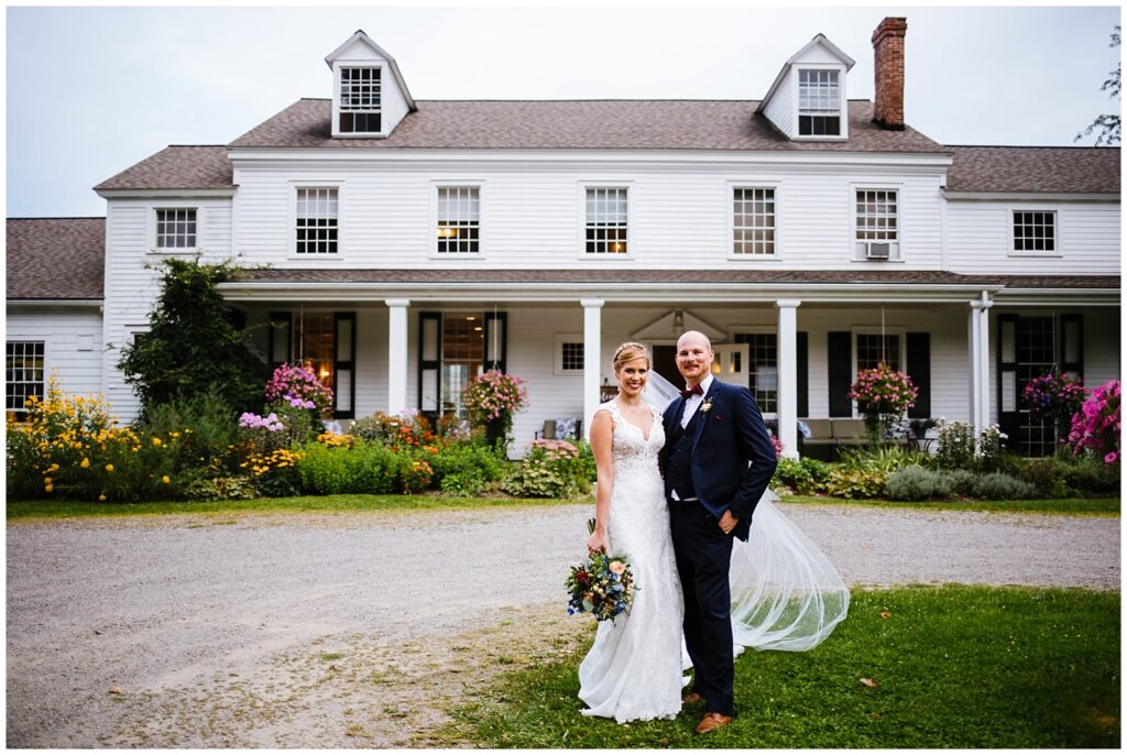 Bride and groom stand in front of the Fontainebleau Inn, one of many finger lakes wedding venues