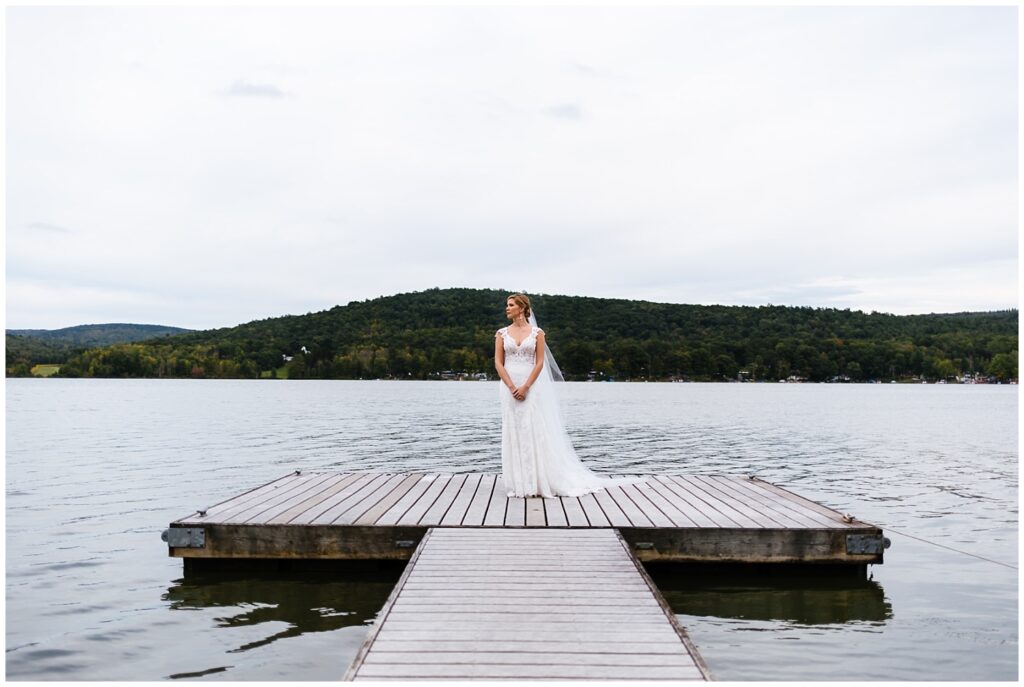 Bride stands on a dock at the FOntainebleau Inn