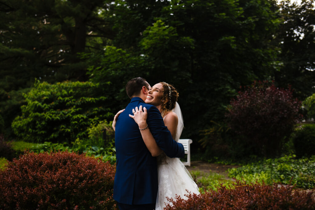 bride and groom hug at the John Joseph Inn in Groton, NY.