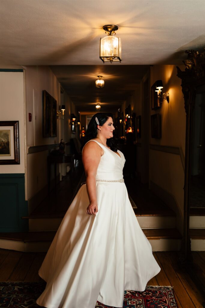 A bride spins at the sherwood Inn, one of many finger lakes wedding venues, located in Skaneateles NY.