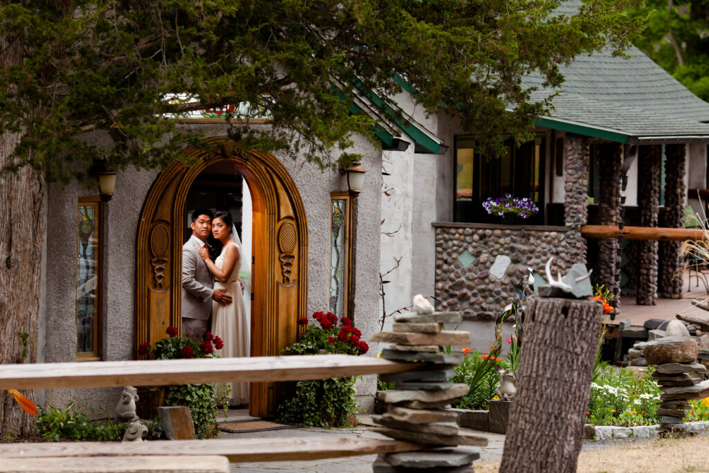 Bride and groom stand inside a hobbit house at New Park Event Venue in Ithaca, NY. 