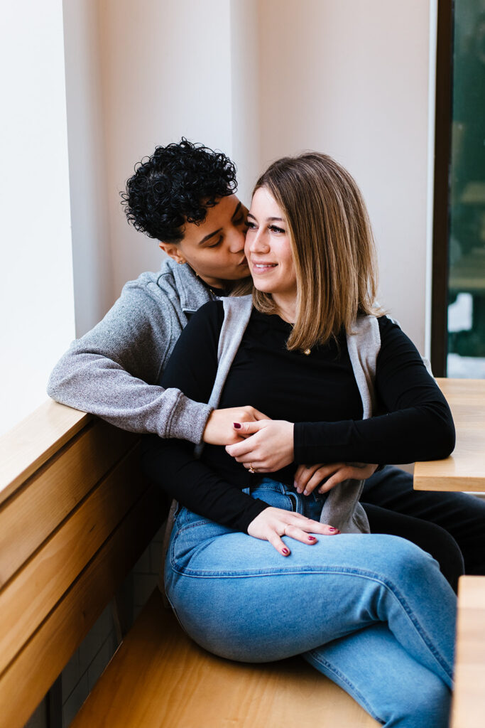 Syracuse wedding photographer, Calypso Rae Photography, took an image of a bride and bride sitting together in Sweet Praxis during their Syracuse engagement session