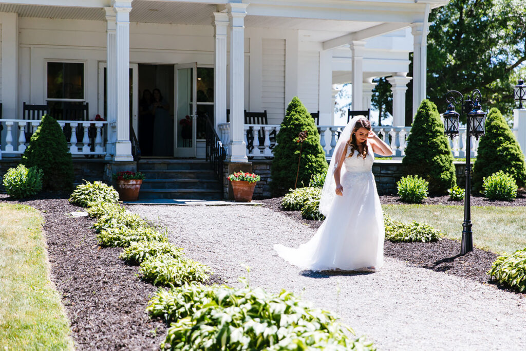 Bride walks in front of the John Joseph Inn.