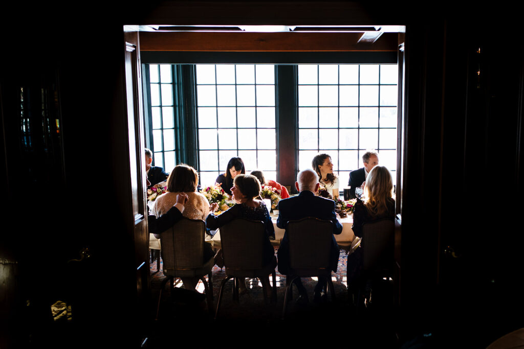 A wedding party eats dinner during an intimate wedding at the Sherwood Inn.