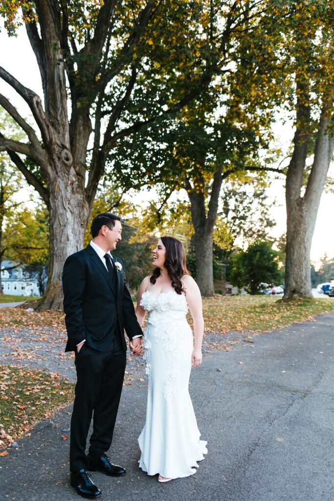 Bride and groom smile at each other at their locust hill country club wedding.