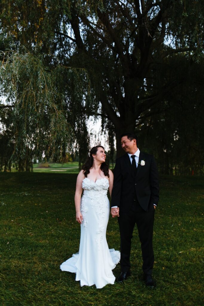 Bride and groom are under a willow at their Rochester, ny wedding in September.