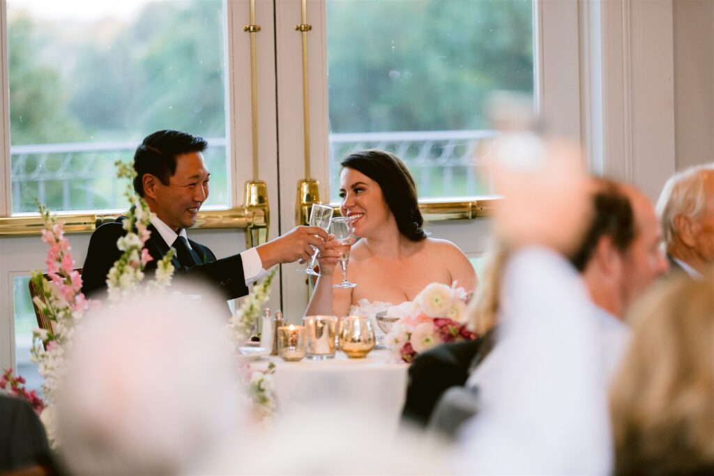 Bride and groom toast at their wedding reception at locust hill country club