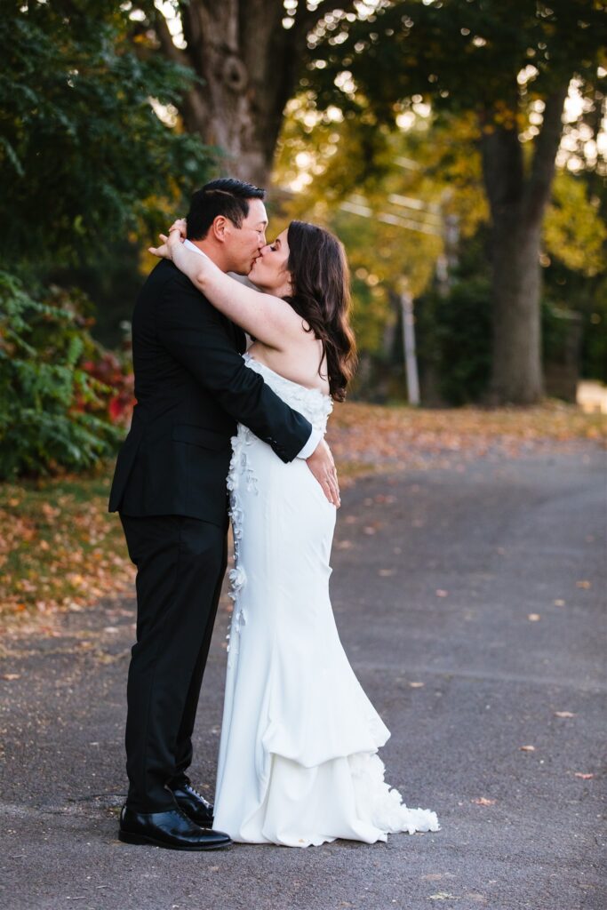 Bride and groom share a kiss at their locust hill country club wedding.