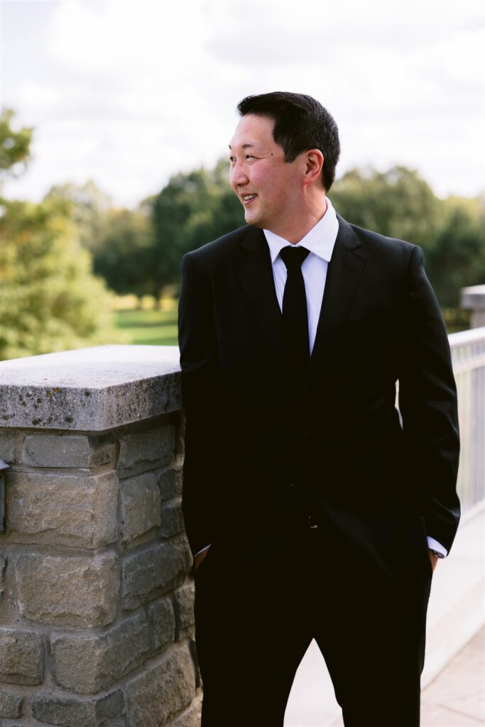 Groom looks out at Locust Hill Country Club.