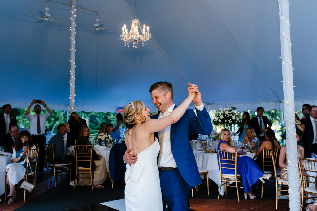 A newlywed couple dancing at their wedding reception 