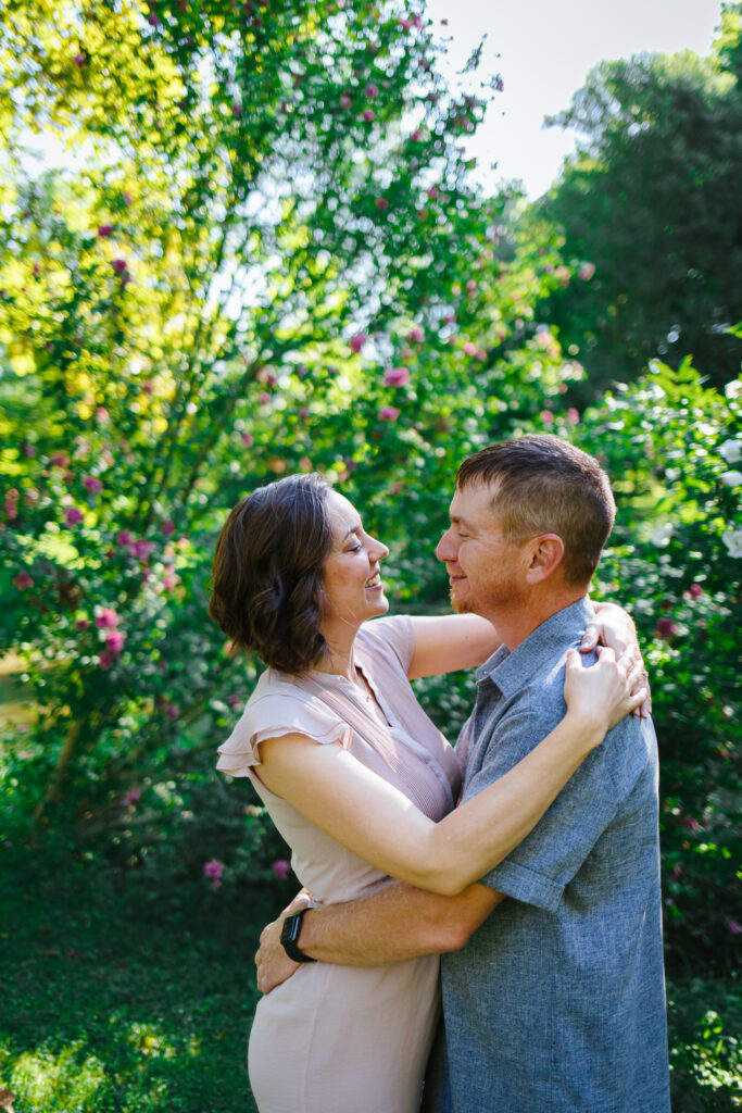 Couple enjoying a romantic moment during their Upstate NY summer engagement session at Marcellus Park