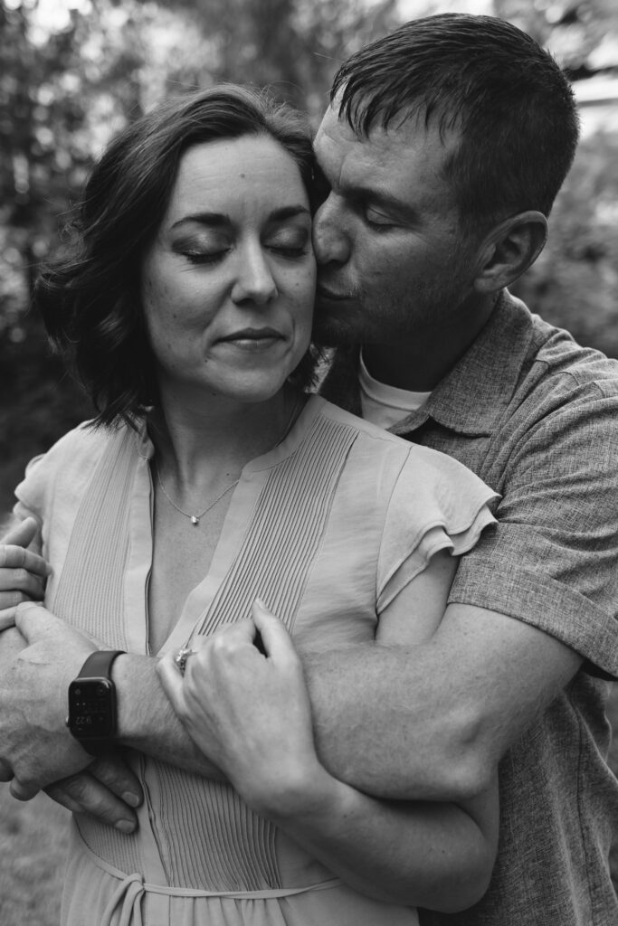 Couple enjoying a romantic moment during their Upstate NY summer engagement session at Marcellus Park.