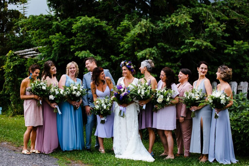 A newlywed with their wedding party smiling and laughing 