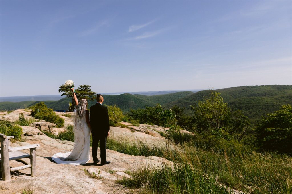 A bride and groom look off over the mountains at their Catskills wedding at Bear Mountain Inn.