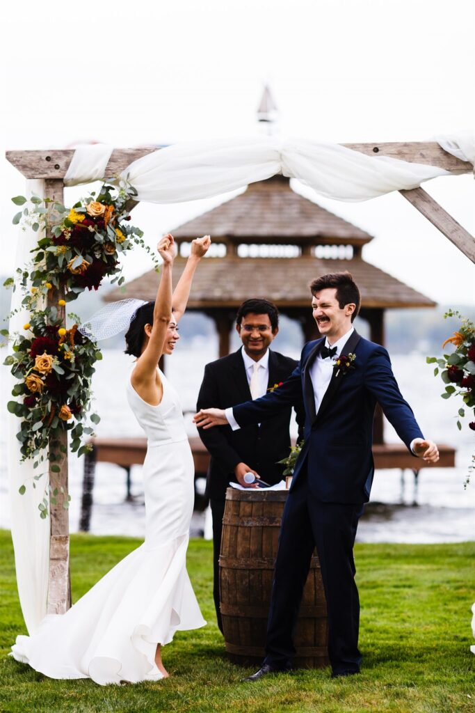 Bride and groom cheer during their wedding ceremony at their Saratoga springs wedding. 