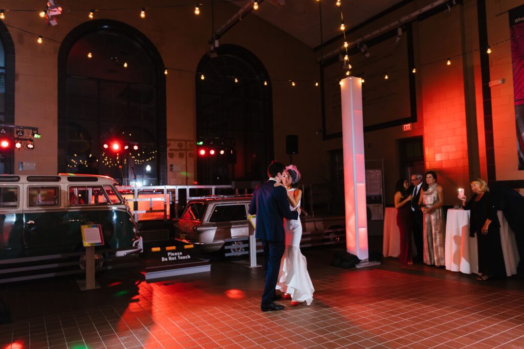Bride and groom have their first dance at their Saratoga Springs wedding in the Saratoga Automobile Museum. 